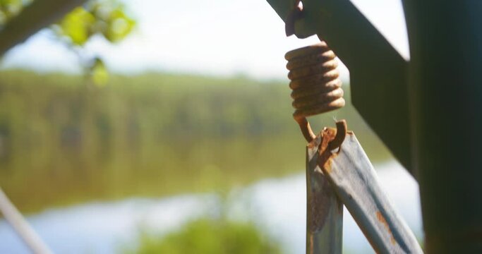 Metal spring attachment view of swinging outdoor hanging swing bench