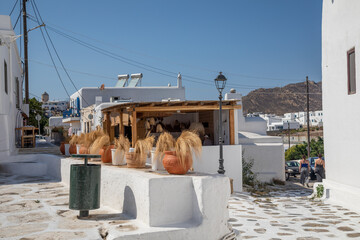 Streetview of Mykonos town with white street and blue door, Greece - 711091762