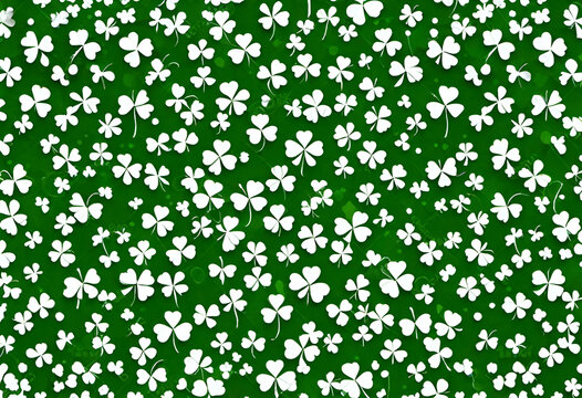 White shamrock clovers on green background