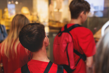 Group of students and school pupils in a science museum exhibition, excursion tour with guide, a docent with a tourist visitors, school field trip, attendees of technical museum exposition gallery