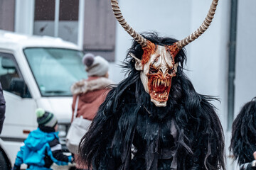 Krampus on street background. Carnival costumes and characters.Winter costume processions on the...