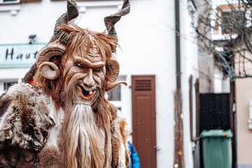 Krampus monster costumes on street background.Carnival processions in Germany.Carnival costumes and...