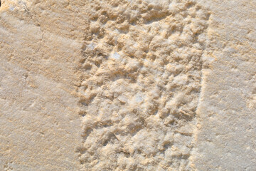 Preparing a stone block from ancient architecture. Background with selective focus and copy space