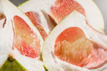 closeup slice of grapefruit fruit with fresh red color, pomelo.