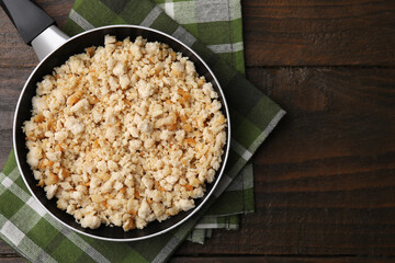 Fried ground meat in frying pan on wooden table, top view. Space for text