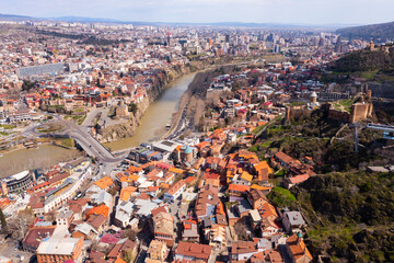 Drone view of the residential areas of the city of Tbilisi, located on the banks of the Kura River and is the capital..of Georgia - obrazy, fototapety, plakaty