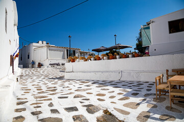 Streetview of Mykonos town with white street and blue door, Greece - 711155718