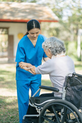 Professional physiotherapist taking care of senior patient during rehabilitation.