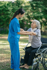Professional physiotherapist taking care of senior patient during rehabilitation.