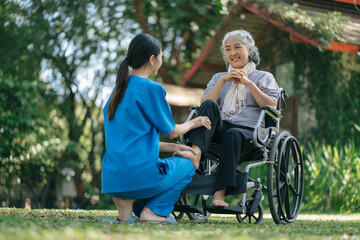 Professional physiotherapist taking care of senior patient during rehabilitation.