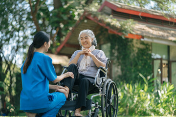 Fototapeta na wymiar Professional physiotherapist taking care of senior patient during rehabilitation.