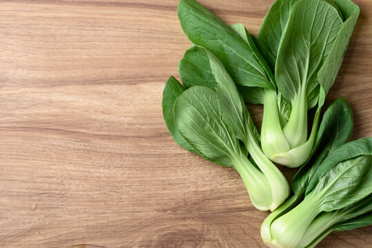 Bok choy or Pak choi (Chinese cabbage) on wooden background, Table top view
