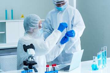 Scientist man look into Microscope research in science laboratory. Asian scientist looking...