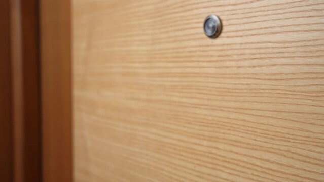 The hand of an angry annoying neighbor knocks on a wooden door due to noise Demanding room service employee wakes you up in the morning Furious wife, caught her husband with his mistress, adultery