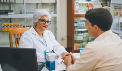 Pharmacist giving advice And advice for patients who come to buy Medicine, Drugs, Vitamins...