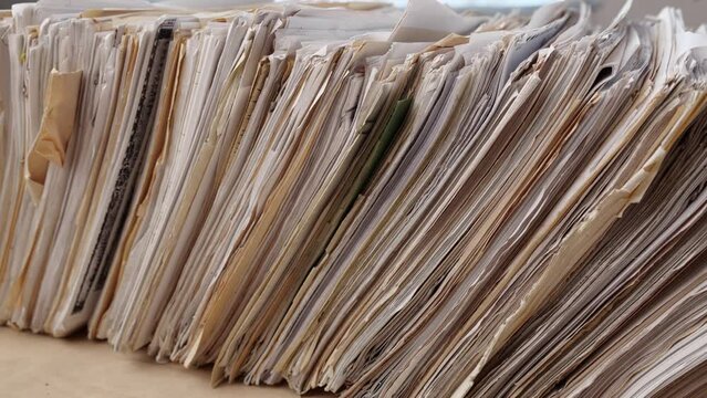 File shelf. The files are old, the paper is yellowed. 