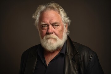 Portrait of a senior man with white beard and mustache. Studio shot.