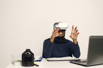 Arabic entrepreneur in her office holding a virtual reality glasses
