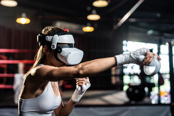 Asian sportswoman using innovative technology VR glasses for exercise. 