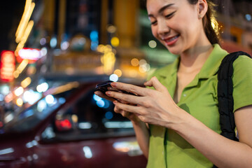 Asian attractive woman traveller chatting on phone while walk in city. 