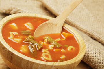 Delicious Canned Vegetable Soup on a wooden background