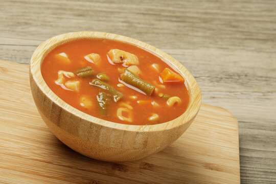 Delicious Canned Vegetable Soup on a wooden background