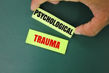 colored paper with the word psychological trauma. the concept of mental health