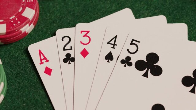 Straight poker hand on green table
