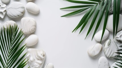 Top view of natural white stones and palm leaves on a white background. Spa background, top view. A tropical summer background for luxury product placement