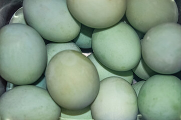 a bunch of green duck eggs
