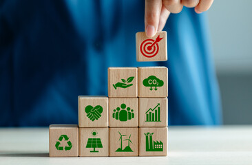 Hand-place wooden with dart board icons, Wooden cubes with ESG icon concepts for Environment,...