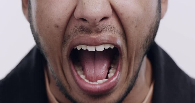 Angry, man mouth and scream with mental health, stress and anxiety from problem in a studio. Fail, issue and frustration of a male person from Dubai with yelling and crazy with white background