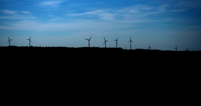 Windmill turbine silhouette/ Matane / Panning to left