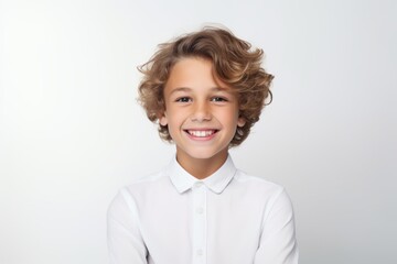 Portrait of a cute smiling little boy in a white shirt on a white background