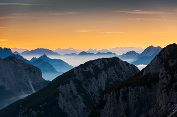 European Alps in Sunset Clouds Close UP Silhouette background - view from Mangart Saddle in...