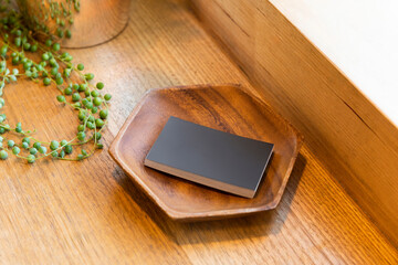Stack of Black Business Cards in Wooden Plate
