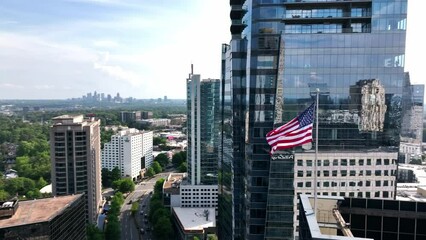 Cinematic drone shot of the American flag waving at building top, Atlanta, Georgia, USA - Powered by Adobe