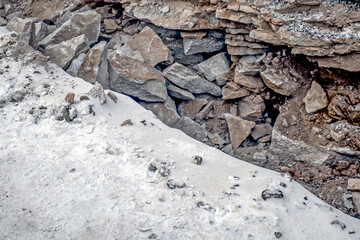 Digging on a snow-covered sidewalk on a winter day