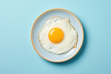 Delicious breakfast with fried egg on blue plate - obrazy, fototapety, plakaty