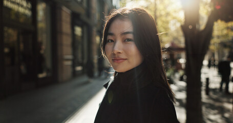 Obraz premium Smile, portrait and Japanese woman in city for tourist sightseeing in the street on weekend trip. Happy, adventure and young female person commuting for travel in road of urban town in Kyoto Japan.