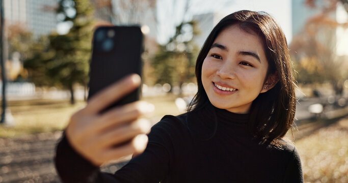 Japanese woman, selfie and smile in park, city or outdoor on web blog, contact or communication. Girl, person and happy influencer for photography, profile picture or memory in nature on social media