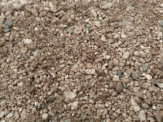Brown white pebbles texture blur background.