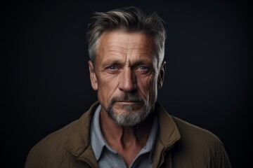 Portrait of a handsome mature man with grey hair and beard. Studio shot.