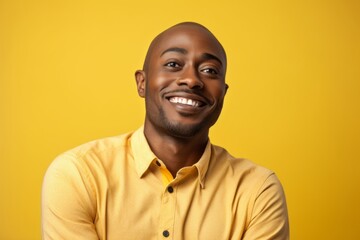 Cheerful african american man looking at camera over yellow background