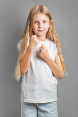 A little girl stands in a fighting pose.