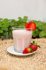 Strawberry smoothie with milk served in a glass beverage breakfast