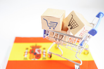 Online shopping, Shopping cart box on Spain flag, import export, finance commerce.