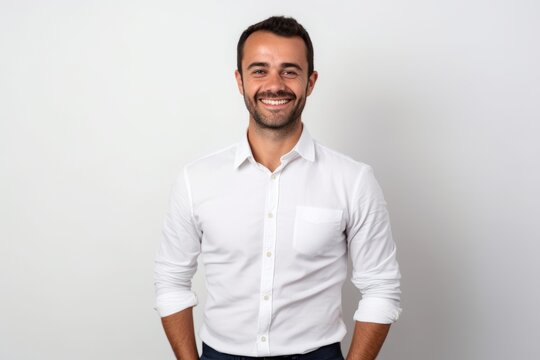 Portrait of a smiling handsome man in white shirt against white background