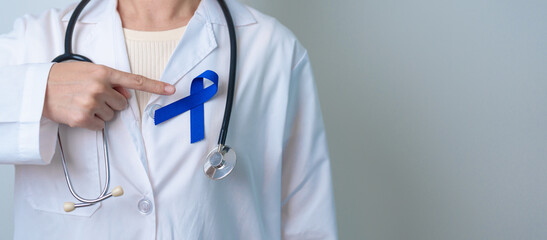 March Colorectal Cancer Awareness month, doctor with dark Blue Ribbon for supporting people living...