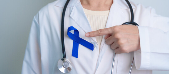 March Colorectal Cancer Awareness month, doctor with dark Blue Ribbon for supporting people living...